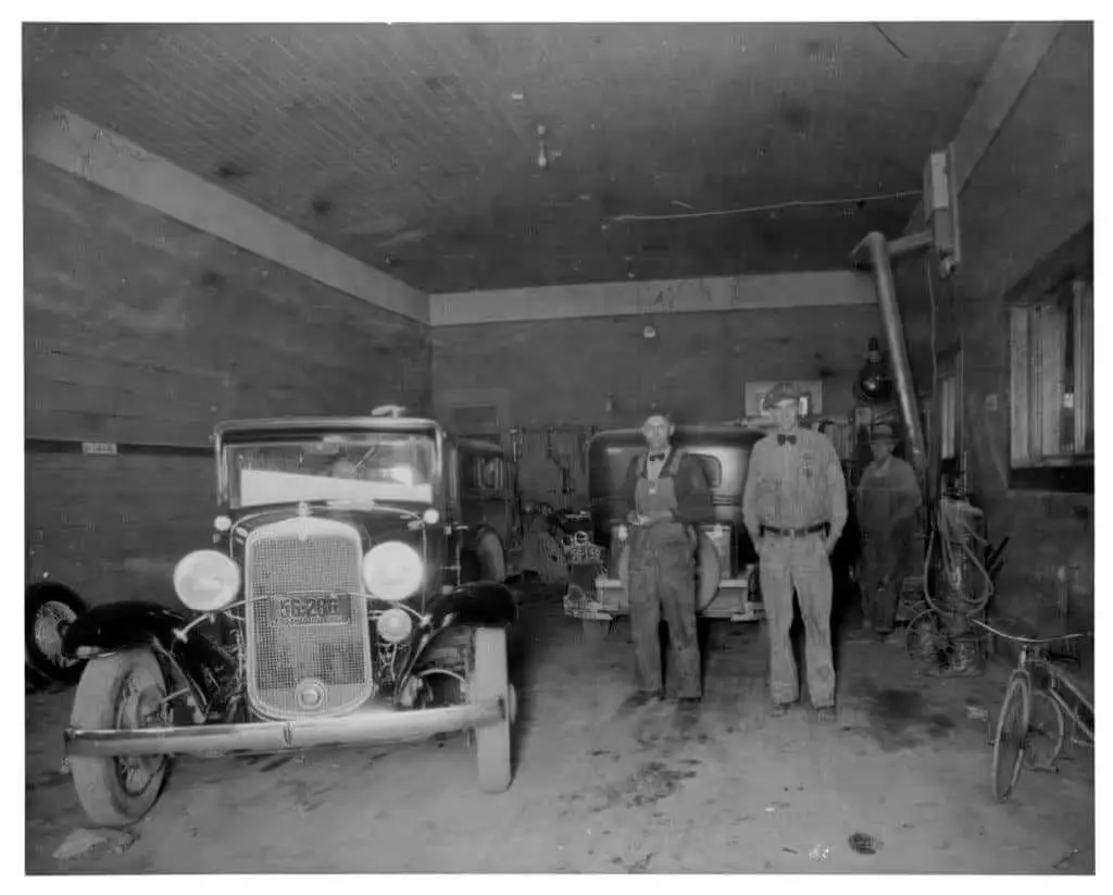 2 men by old car.